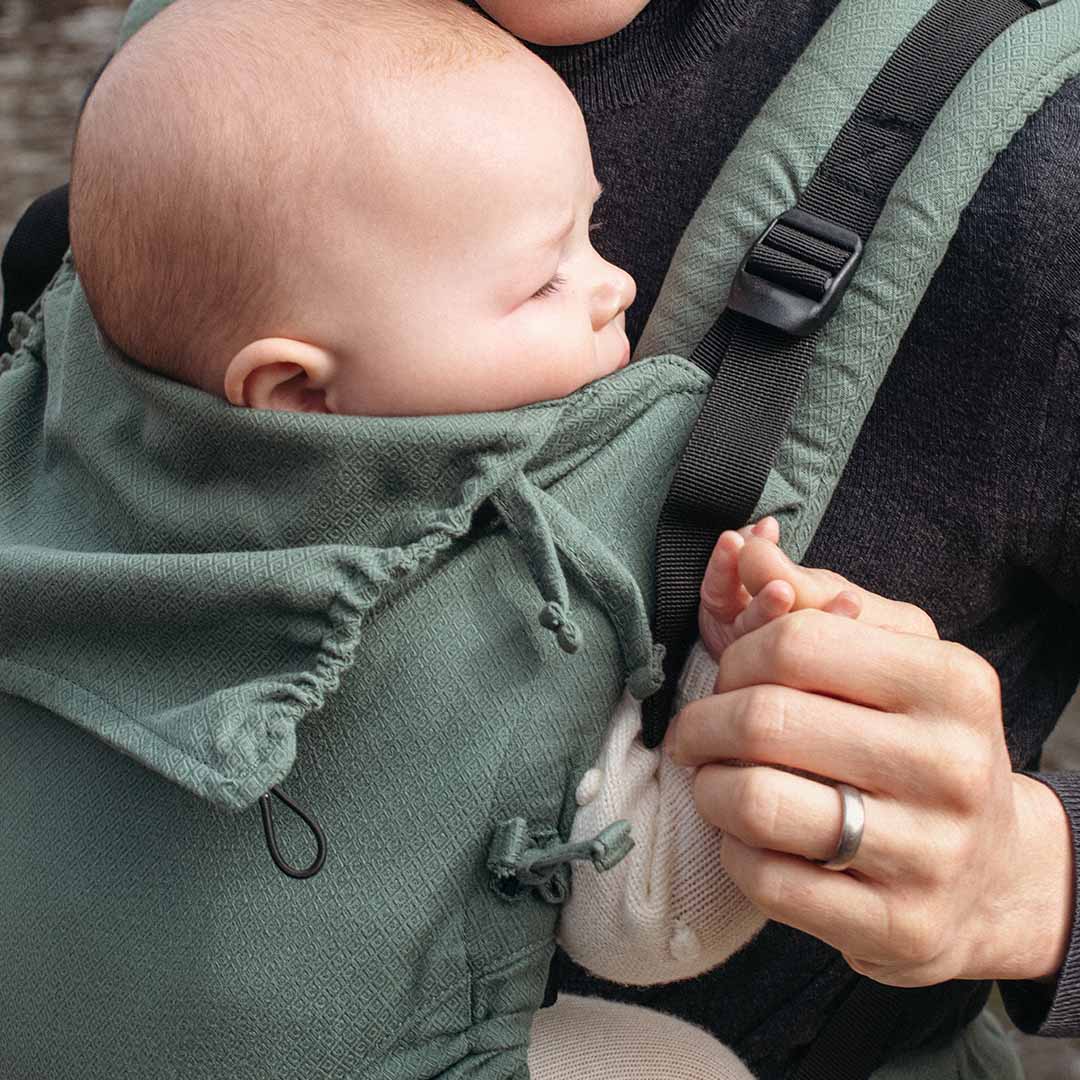 Quokkababy E-Carrier - Green Diamond featuring a baby comfortably nestled in a versatile ergonomic carrier | Babymaxi