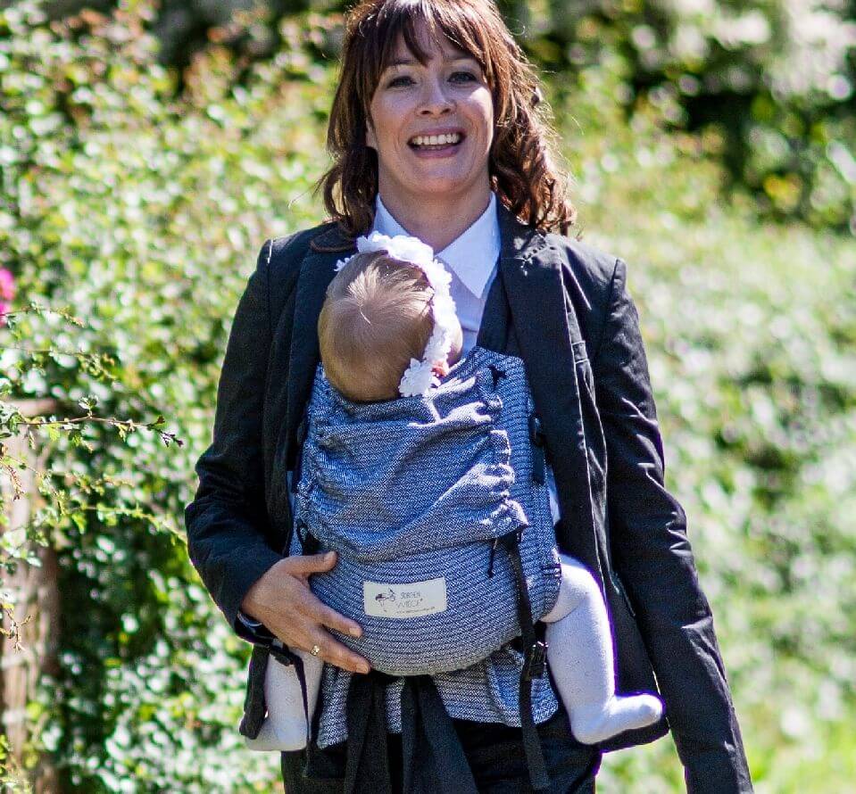 Happy parent wearing the Storchenwiege Talemo Half-Buckle Baby Carrier - Leo Black White with baby | Babymaxi