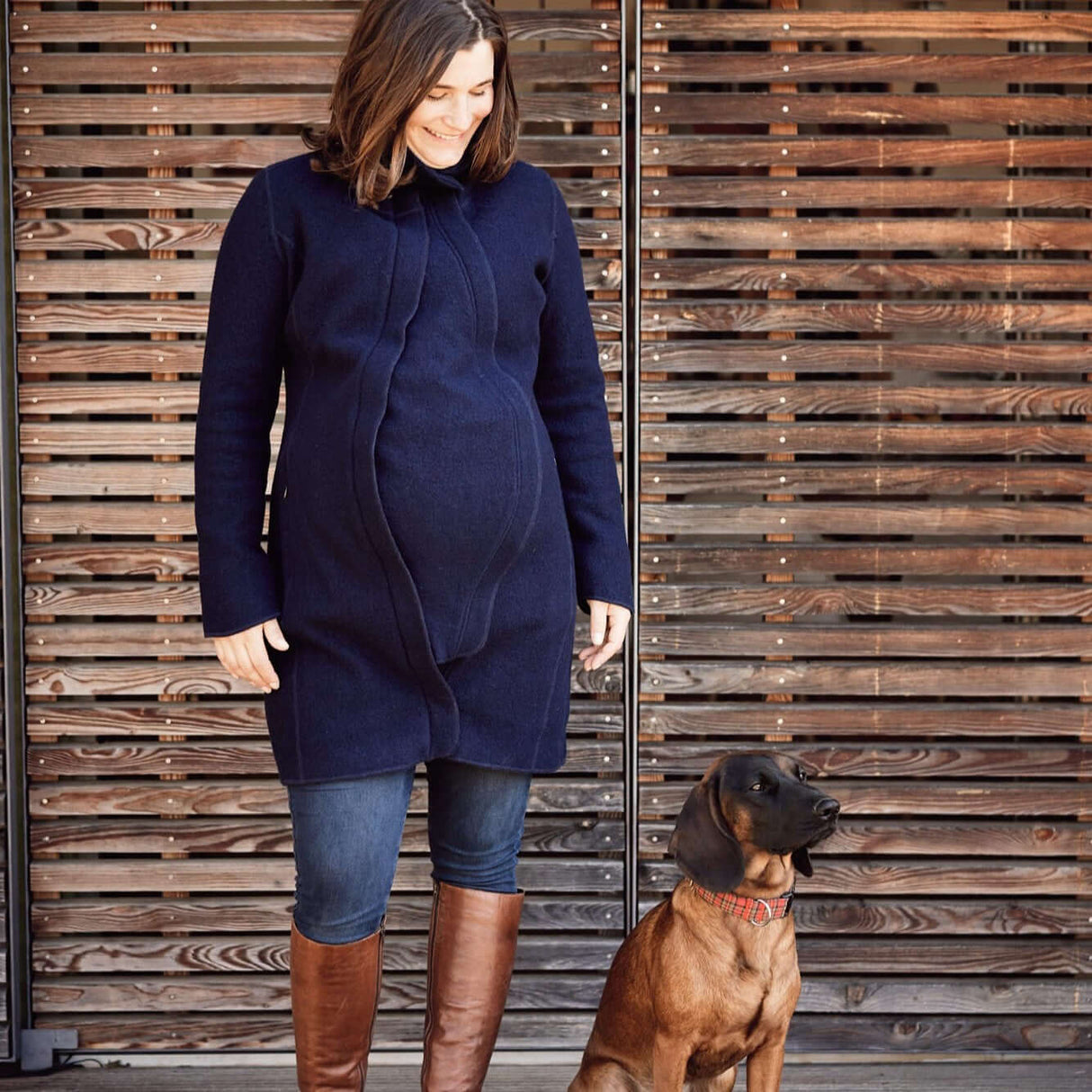 Mamalila Eco Wool Babywearing Coat Oslo - Navy worn by a pregnant woman with dog, showcasing versatility for pregnancy and babywearing | Babymaxi