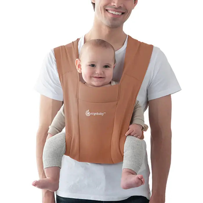 Ergobaby Embrace - Canyon Clay baby carrier worn by a father with a smiling baby, perfect for comfort and ease of use | Babymaxi