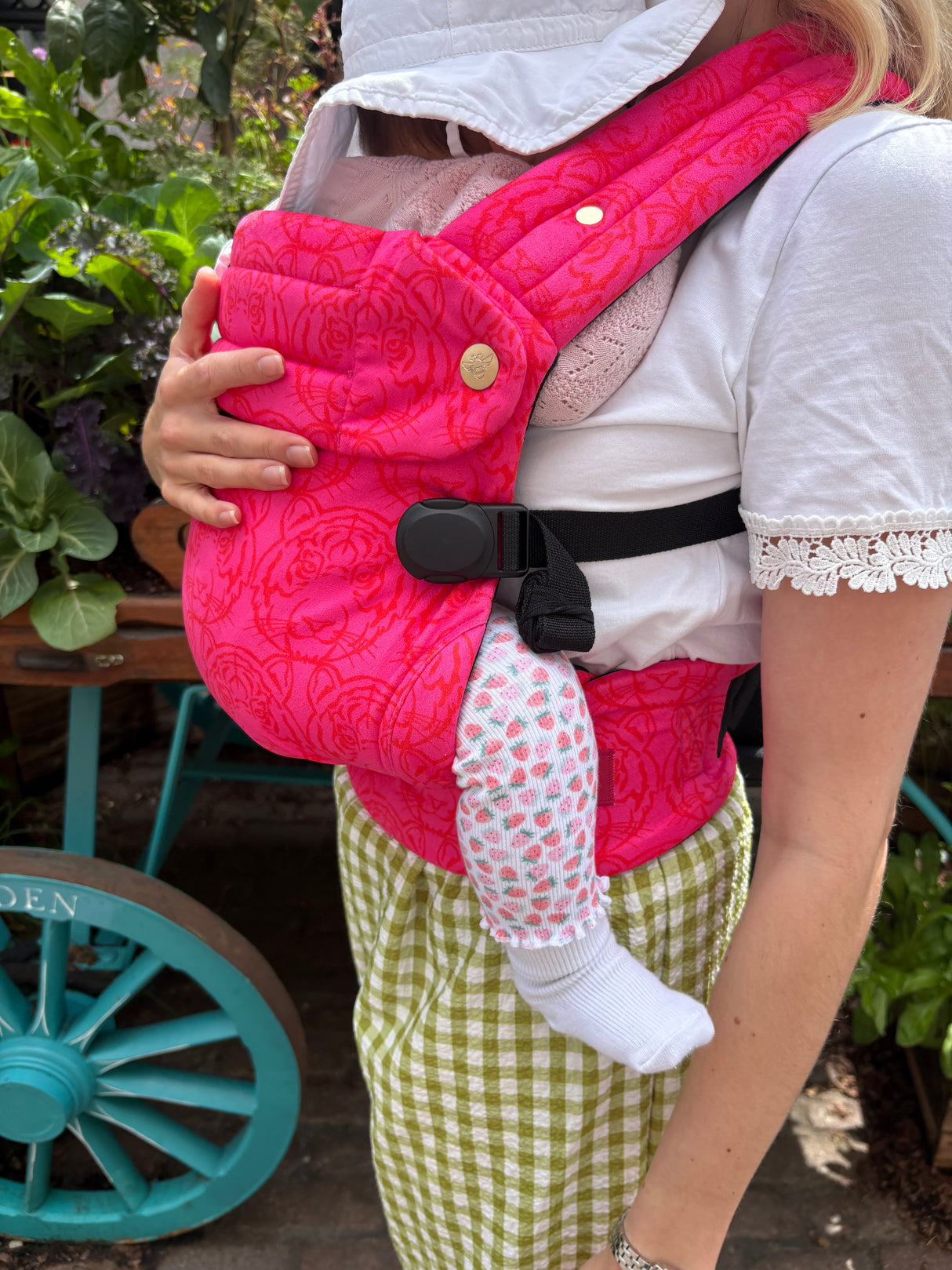 Nomad Air Roar baby carrier detail shot showing pink tiger print fabric and adjustable buckle