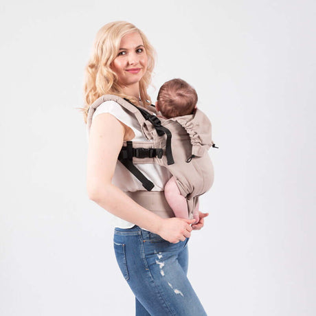Isara The One - Caffe Latte baby carrier with mother carrying infant, adjustable ergonomic design, perfect for all adventures | Babymaxi
