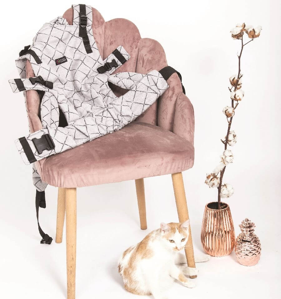 Isara The One - Diamonda Grey baby carrier on a pink chair with a cat | Babymaxi