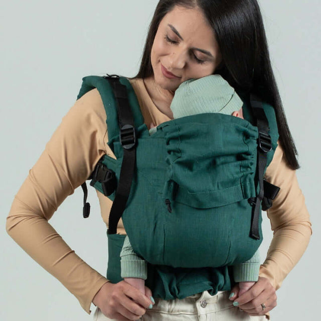 Isara The One - Evergreen Linen baby carrier worn by a parent with an infant, showcasing comfort and support | Babymaxi