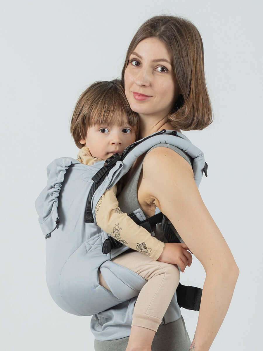 Isara The One - Pearl Grey baby carrier supporting a toddler comfortably, perfect for family adventures | Babymaxi