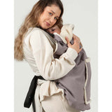 Mother carrying baby in Isara Winter Baby Carrier Cover - Frosted Almond Taupe, keeping warm in cold weather | Babymaxi
