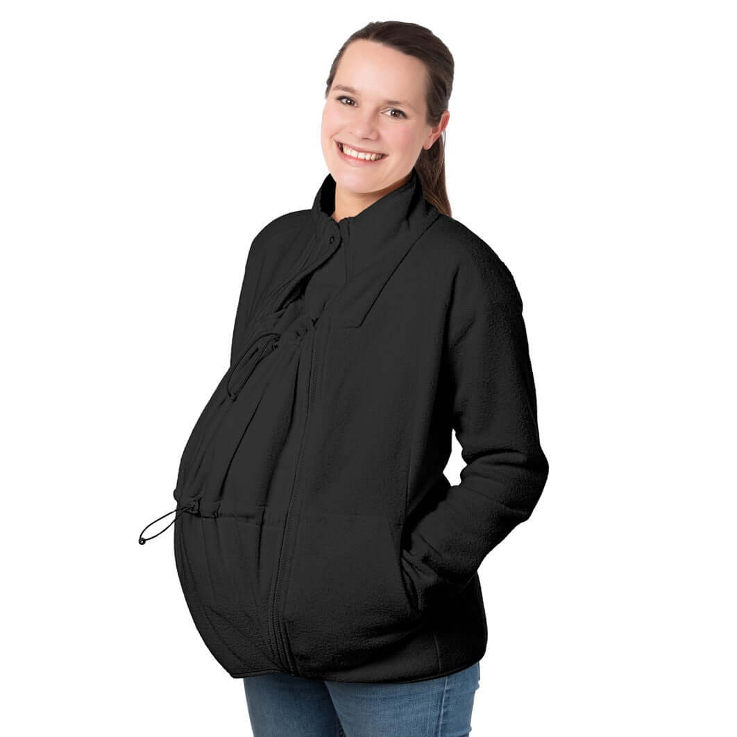 Mamalila Basel Baby Carrier Fleece Jacket – Black worn by a smiling mother for cozy baby wearing warmth | Babymaxi