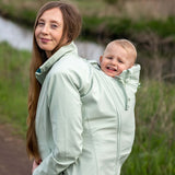 Mamalila Softshell Babywearing Jacket Allrounder - Mint worn by mother with baby, showcasing style and functionality | Babymaxi