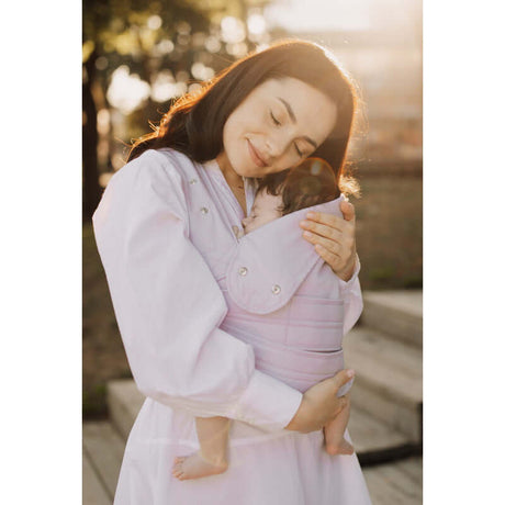 Woman wearing Marsupi Breeze - Lilac baby carrier, securely holding her baby for comfort and support | Babymaxi