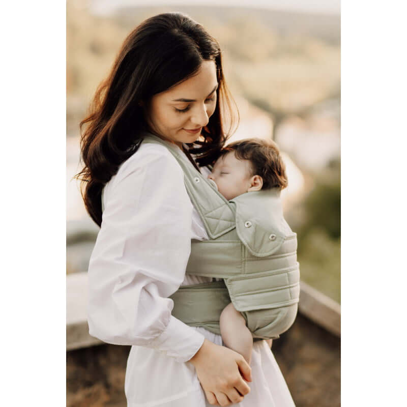 Mom using the Marsupi Breeze - Pistachio baby carrier with her sleeping baby, showcasing comfort and style | Babymaxi