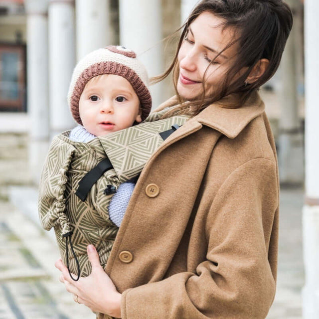 Neko Switch Baby Size - Cedar ergonomic carrier for baby in cozy wrap held by smiling parent | Babymaxi