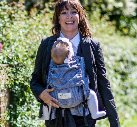 Happy parent wearing the Storchenwiege Talemo Half-Buckle Baby Carrier - Leo Black White with baby | Babymaxi