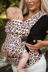Baby's face visible in Nomad Air Dusky Leopard carrier with mother adjusting the buckle and smiling